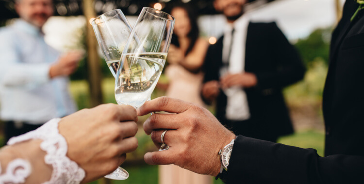 a bride and groom toasting champagne 
